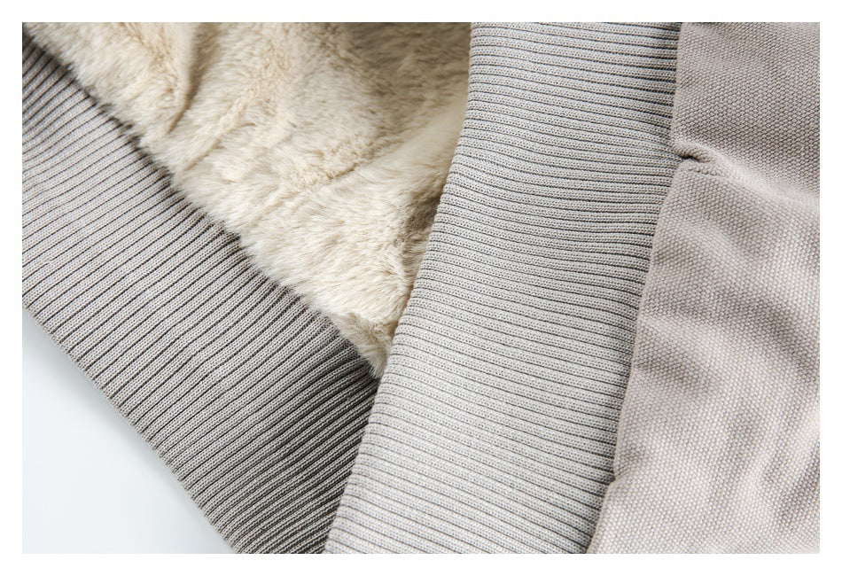 Close-up showing the jacket's cream plush lining, taupe-gray outer fabric, and ribbed trim.