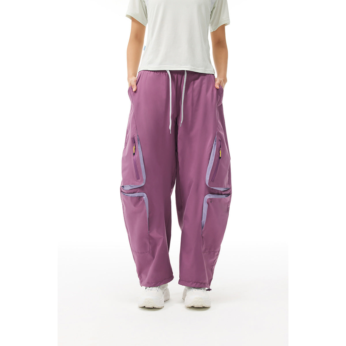 Model wearing mauve wide-leg cargo pants with a drawstring waist, zip pockets and large flap pockets.