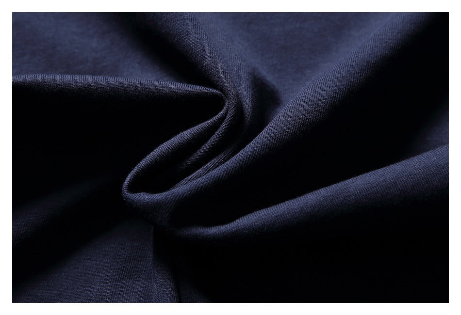 Close-up of folded navy shirt fabric showing its surface texture and drape.