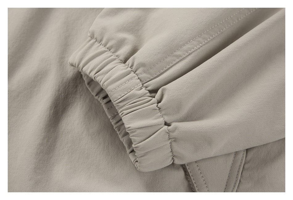 Close-up of a gathered elastic cuff on a light taupe garment.