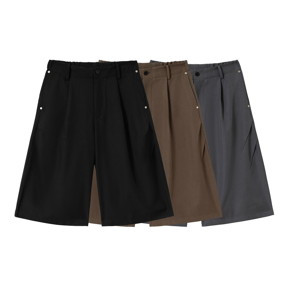 Three pairs of wide-leg shorts shown together in black, brown and charcoal gray.