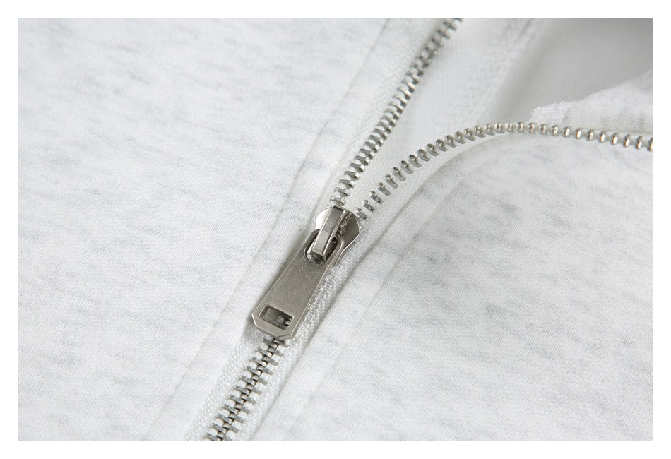 Close-up of the jacket's silver metal zipper and zipper pull.