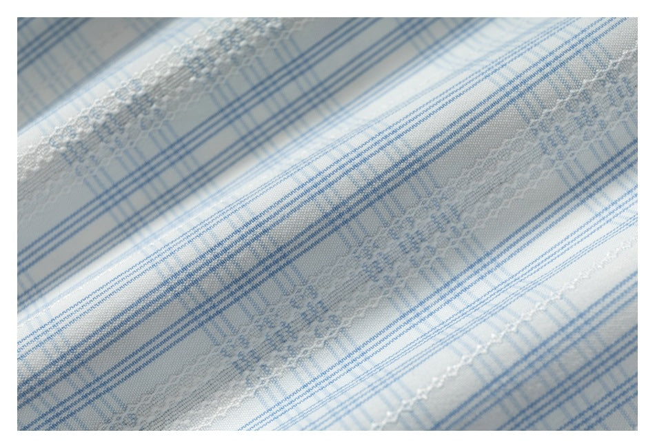 Close-up of pale blue and white striped fabric with floral woven bands.