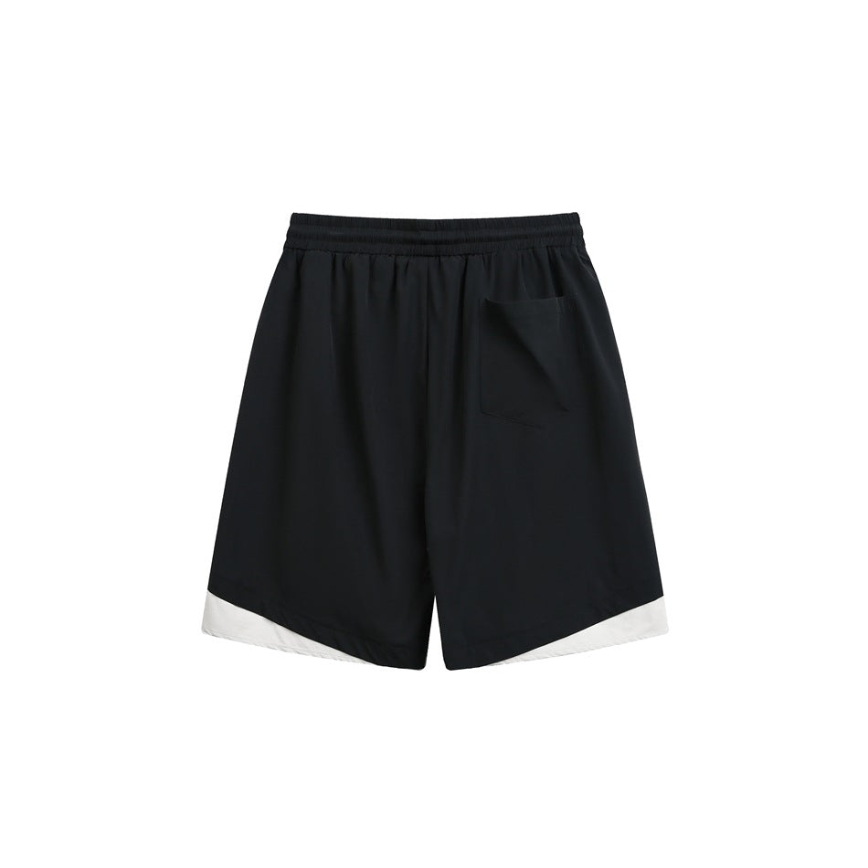 Back view of black shorts with an elastic waistband, a rear patch pocket, and off-white hem panels.