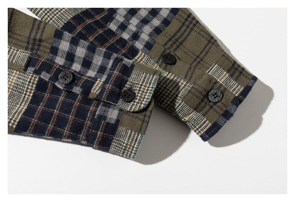 Close-up of the buttoned cuff on an olive, navy, gray, and cream plaid shirt.