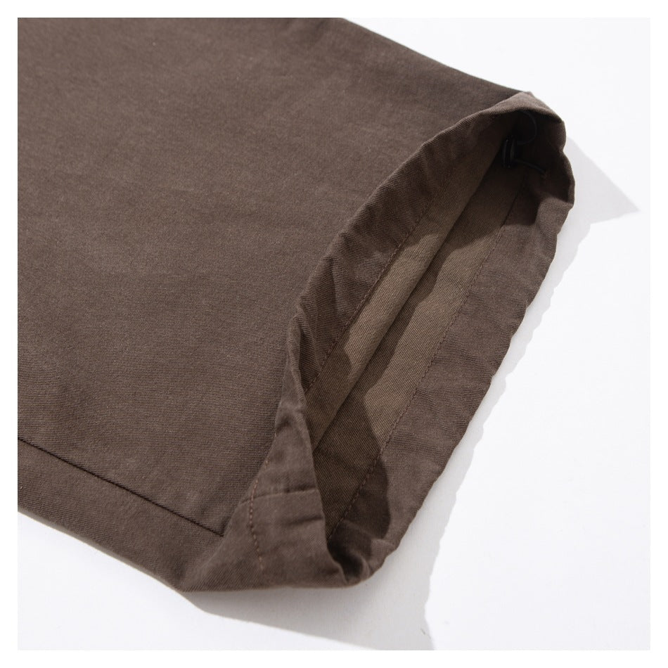 Close-up of the finished hem and inner seam of a brown pants leg.