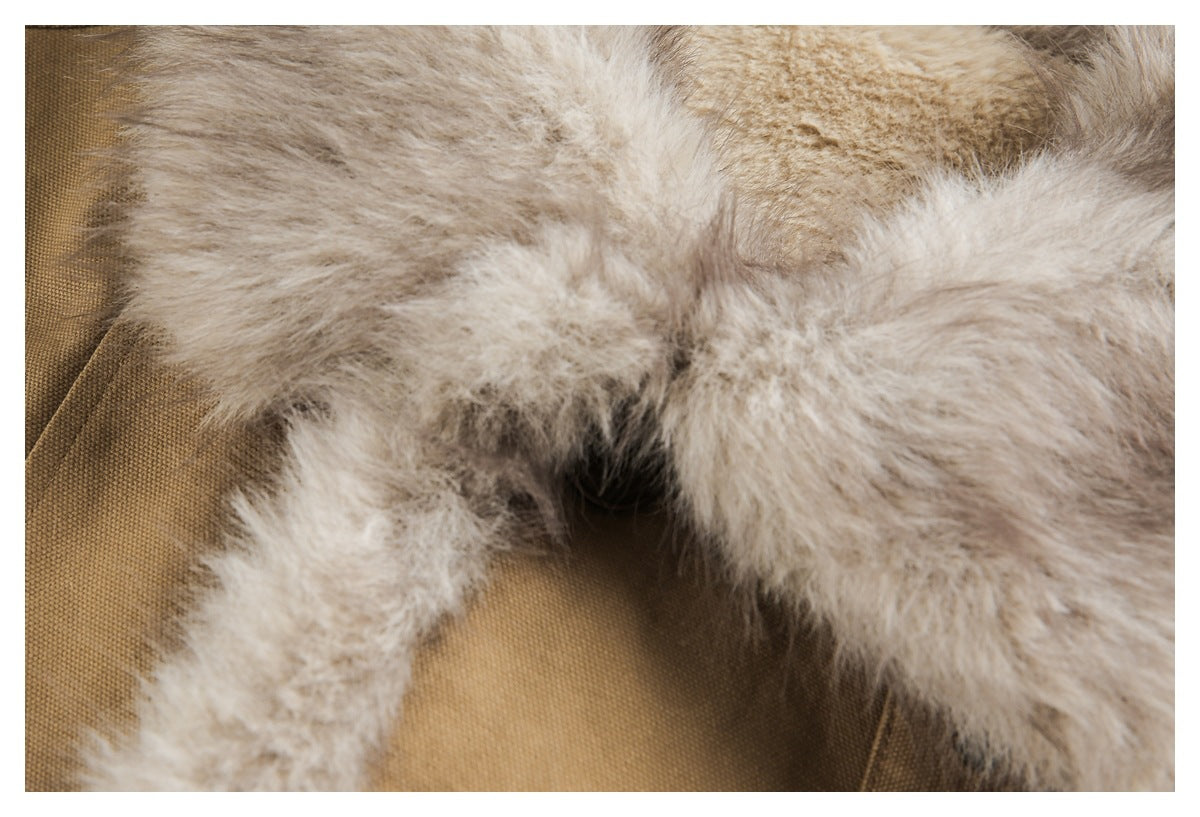 Extreme close-up of the jacket's fluffy light fur trim against tan fabric.