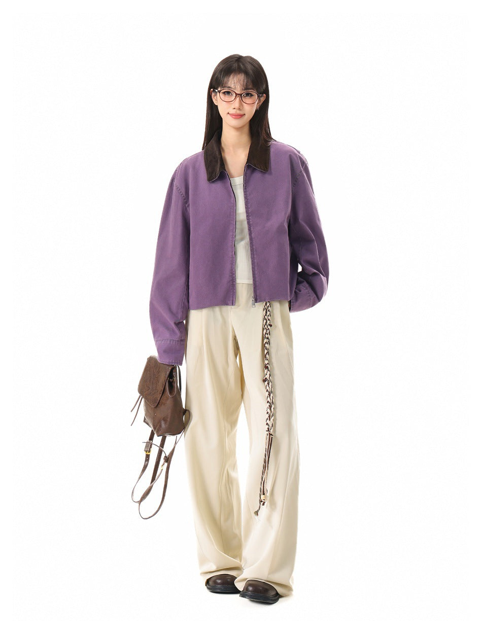 Full-length front view of a model wearing a purple cropped jacket with a dark collar and cream wide-leg trousers.