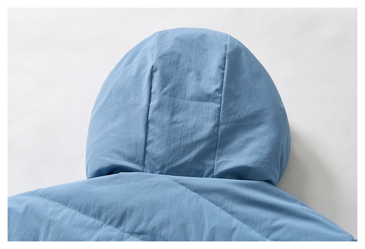 Close-up of a light blue jacket hood and upper back, showing panel seams.