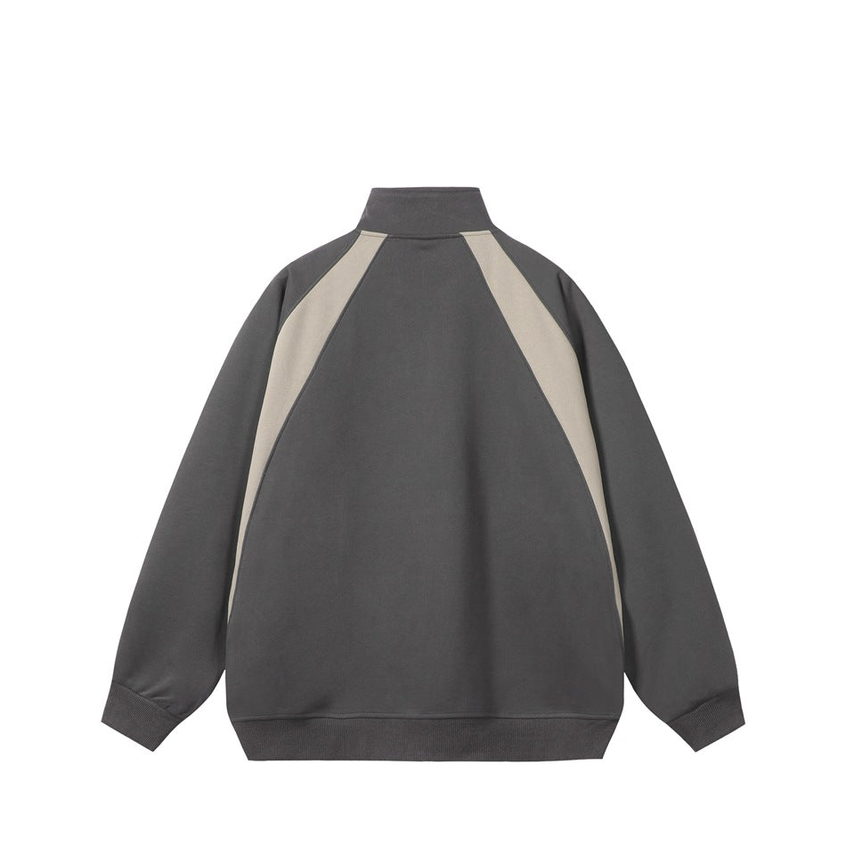 Back view of dark gray jacket with light beige raglan panels, stand collar and ribbed cuffs and hem