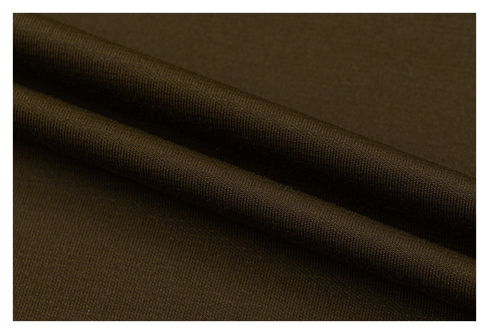 Extreme close-up of olive fabric draped into folds, showing its fine knit texture.