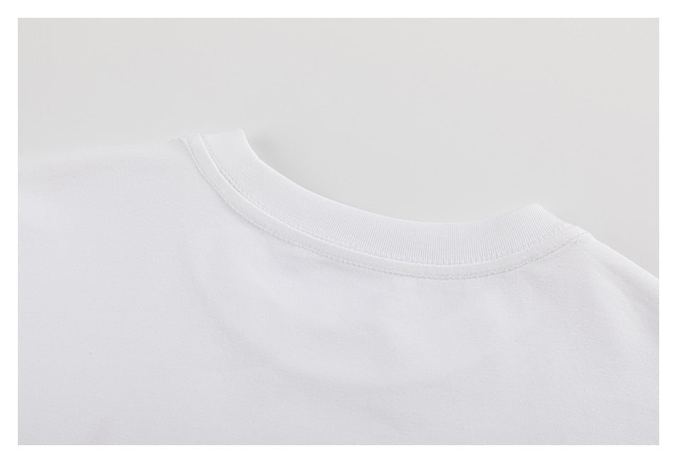 Close-up of the ribbed crew neckline and stitching on a white shirt.