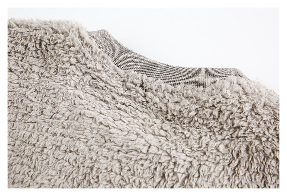 Close-up of plush gray fabric at the neckline with a gray rib-knit collar.