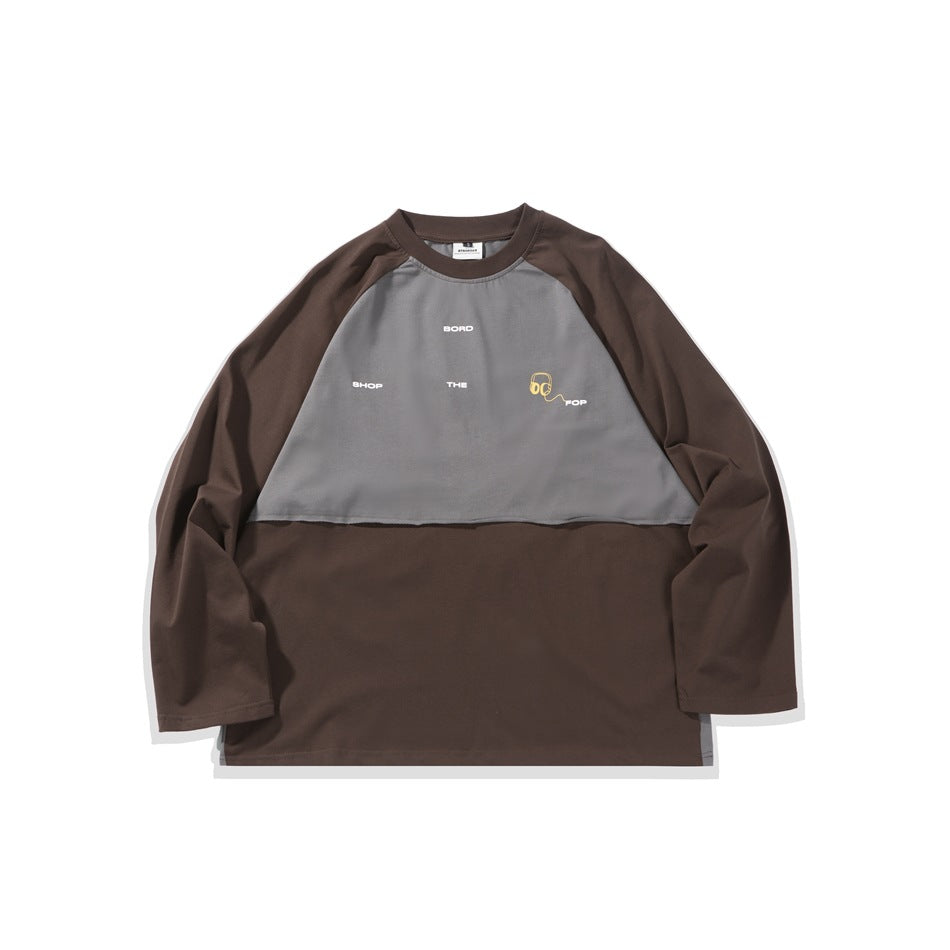 Brown long-sleeve crew-neck top with gray chest panel, white lettering and yellow headphone graphic, flat view