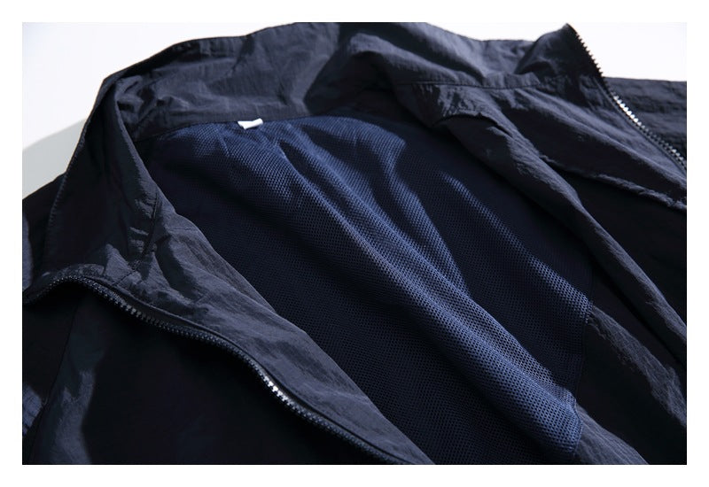 Open dark jacket showing its navy mesh lining and front zipper.