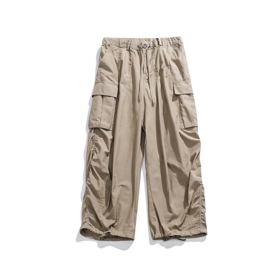 Khaki wide-leg cargo pants flat lay with elastic waist, drawstring, side flap pockets and ruched sides