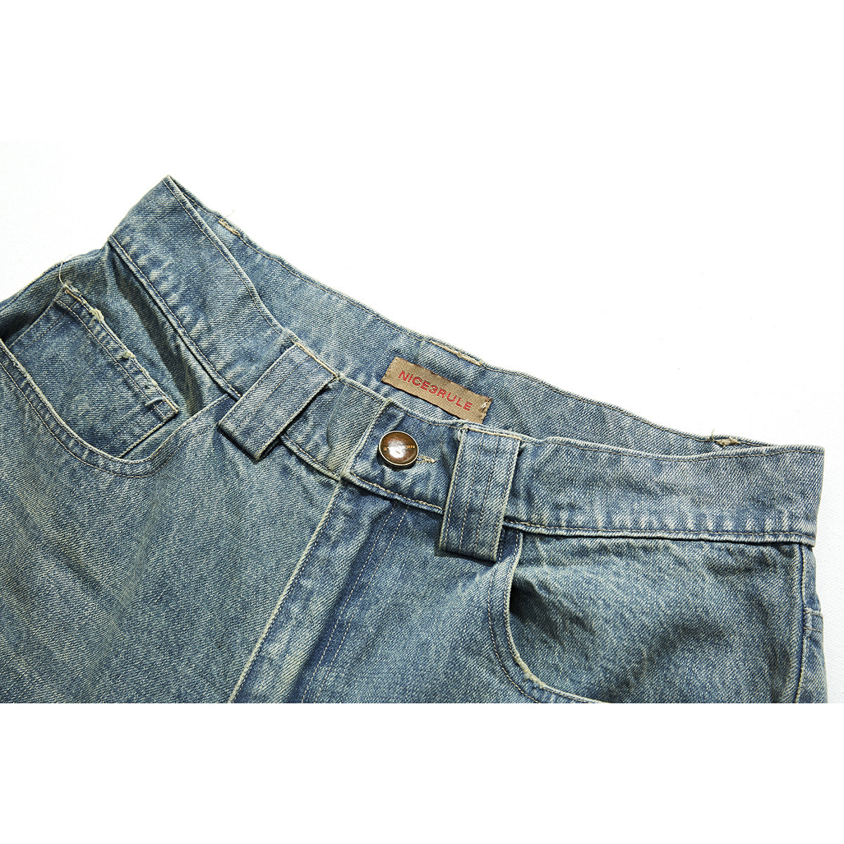 Close-up of light blue faded jeans showing the waistband, button, belt loops and front pocket.