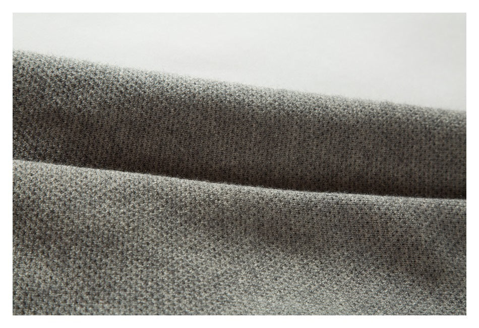 Close-up of folded layers showing the gray garment's knit texture and edge.