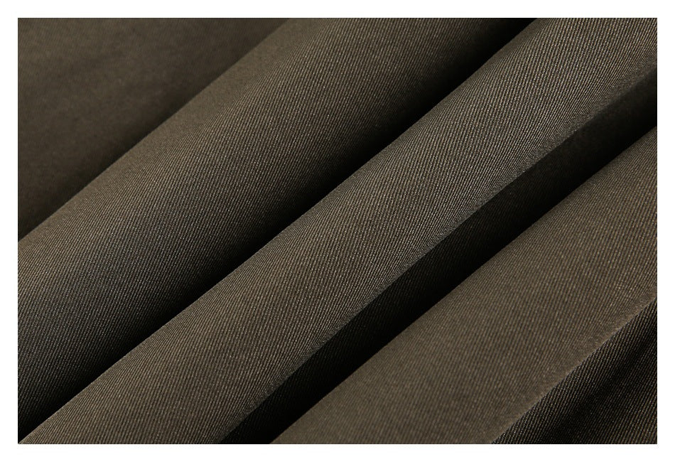 Macro view of olive-brown garment fabric arranged in diagonal folds.
