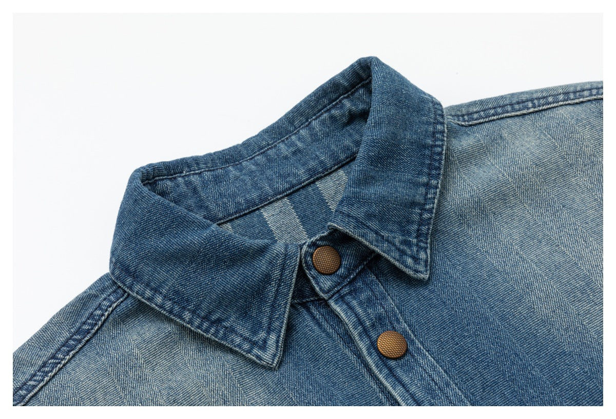Close-up of the blue denim shirt jacket collar and front placket with brown snap buttons.