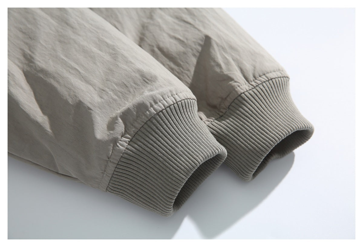 Close-up of the taupe jacket's sleeves and wide ribbed cuffs.