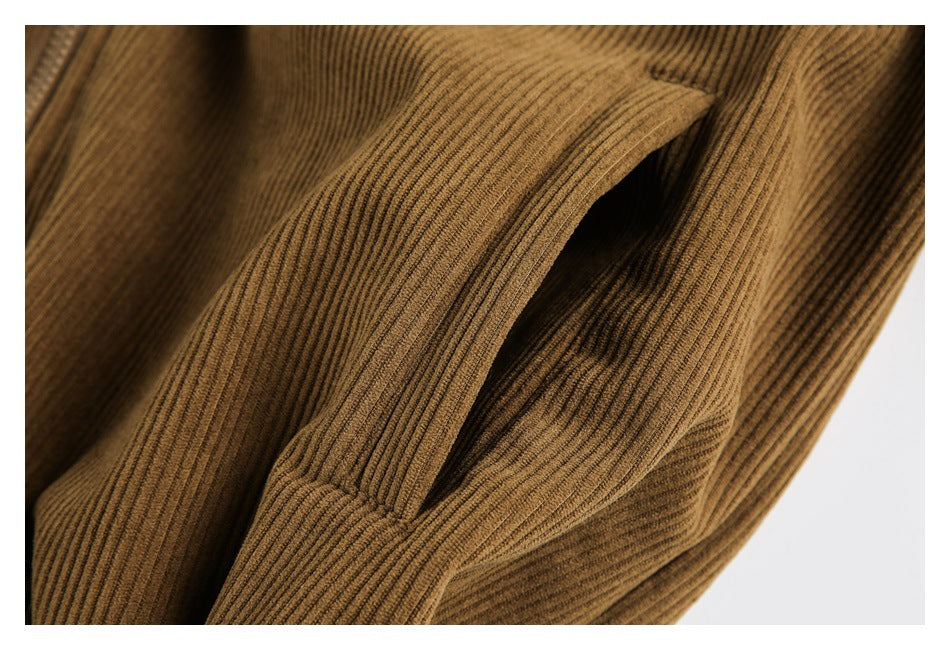 Close-up of a slanted pocket opening on the camel-brown ribbed jacket.