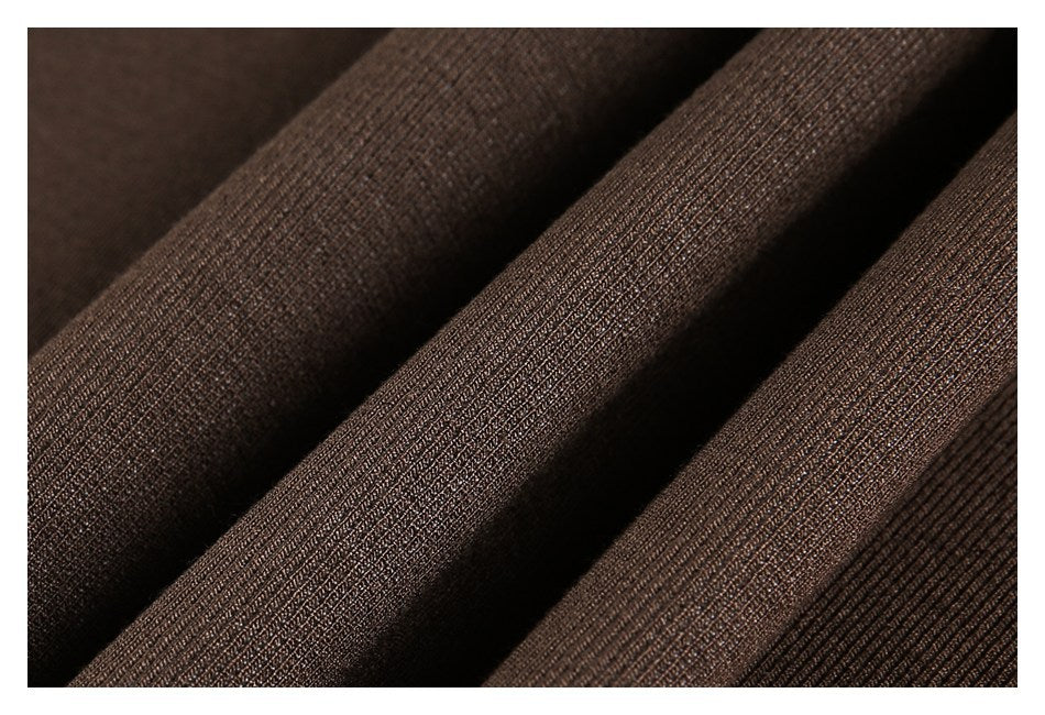 Close-up of brown rib-knit fabric arranged in soft folds.