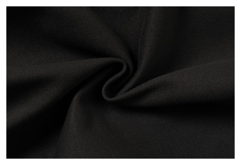 Close-up of black fabric gathered into soft folds.