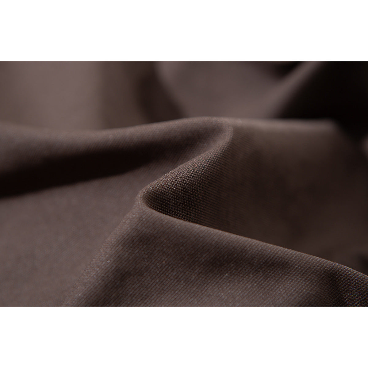 Macro view of the dark brown jacket fabric, showing its woven surface and folds.