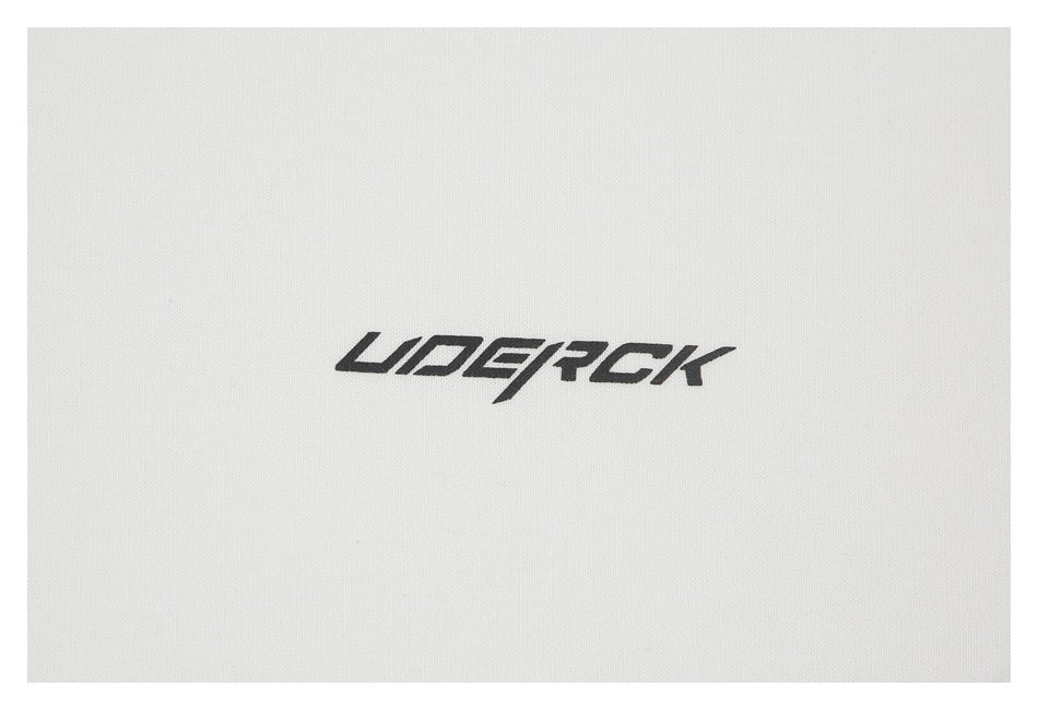 Close-up of a black stylized wordmark printed on white garment fabric.