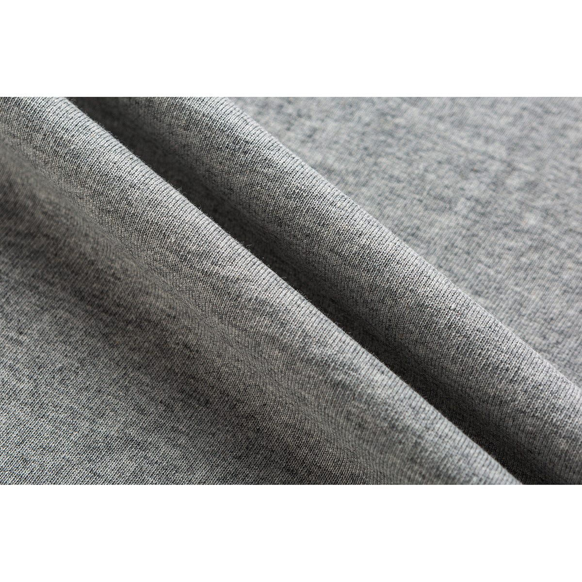 Close-up showing the heather-gray T-shirt fabric draped in soft folds.