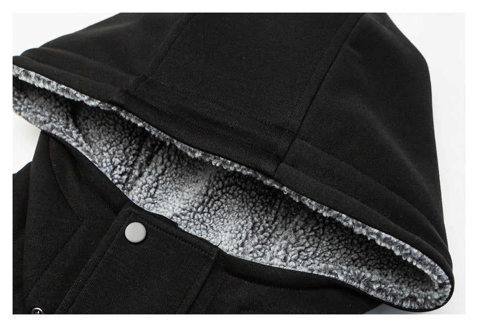 Close-up of a black jacket hood with gray fleece lining and a silver snap fastener.