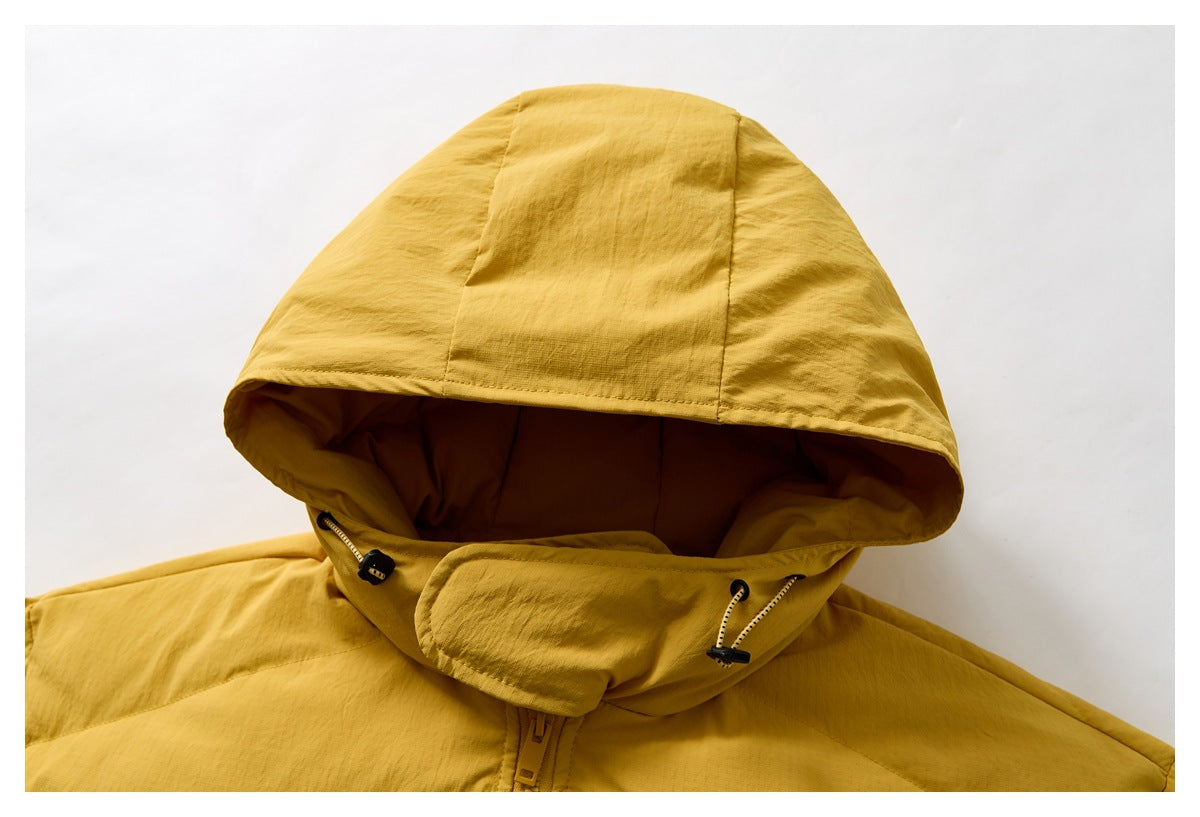 Close-up of the mustard-yellow jacket's hood, drawcord toggles, and upper zipper.