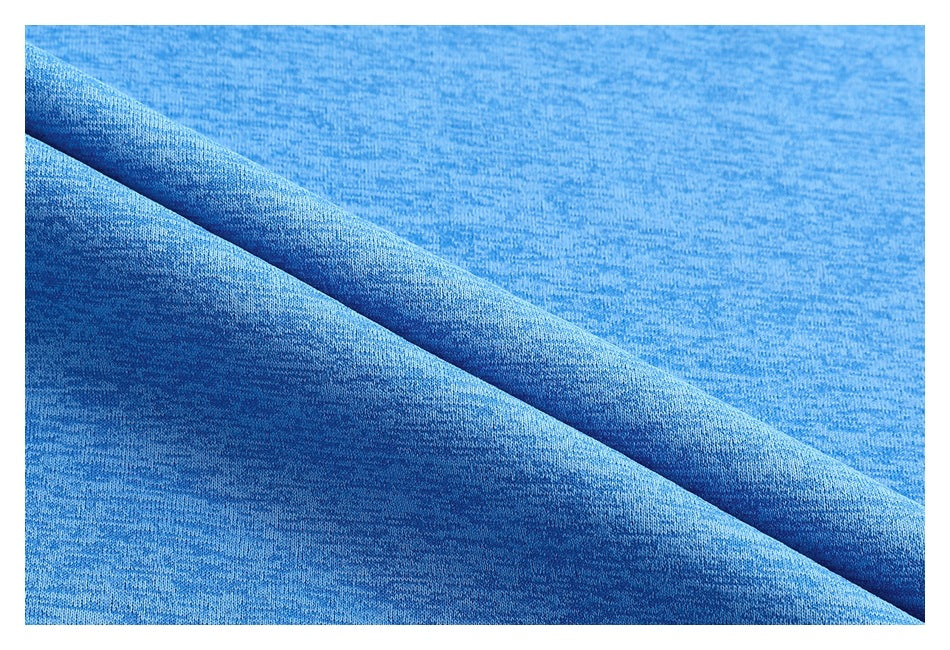 Close-up of blue heathered fabric folded to show its surface and drape.