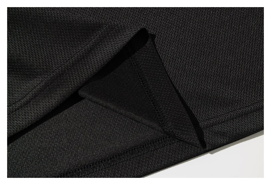 Close-up showing the stitched hem and folded edge of black textured fabric.
