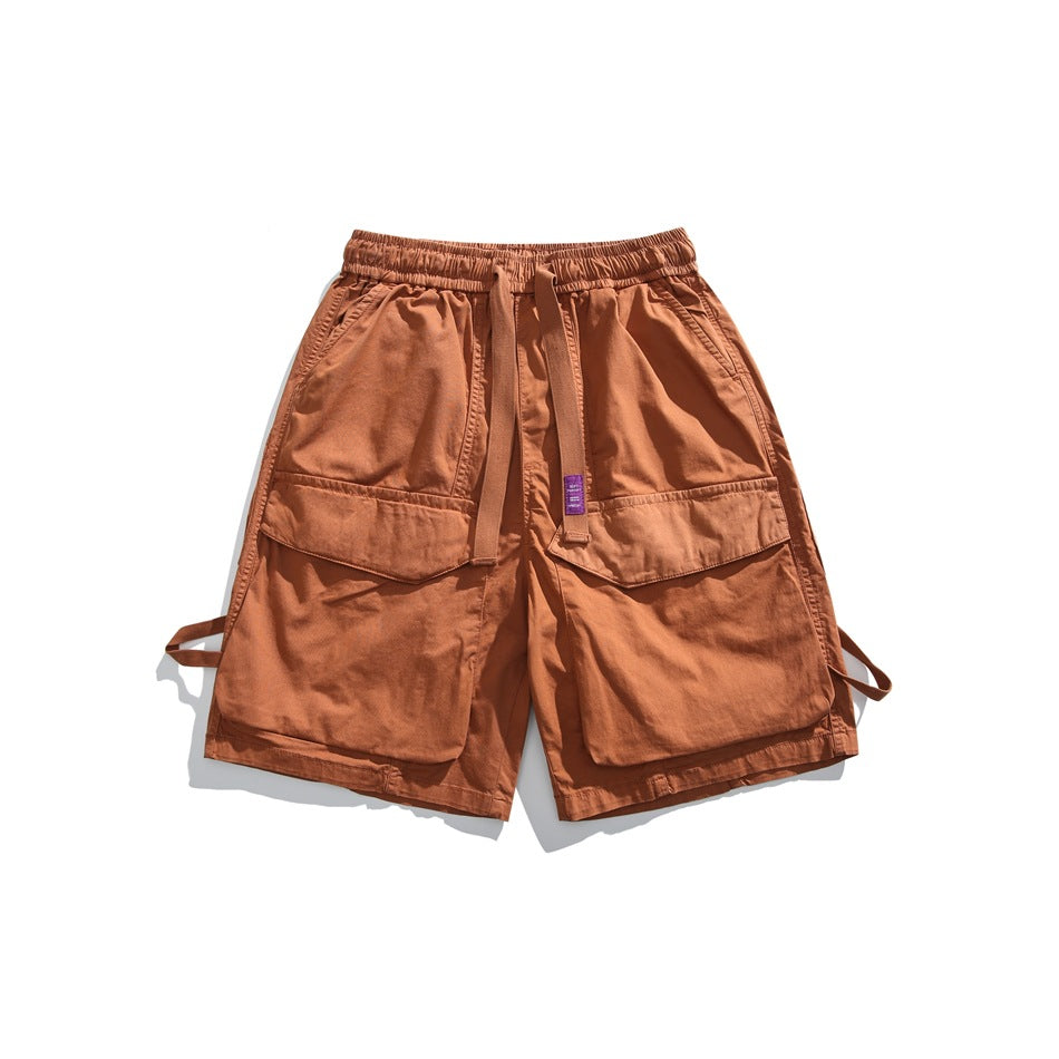 Caramel orange cargo shorts with big flap pockets, elastic waistband and front strap with purple label