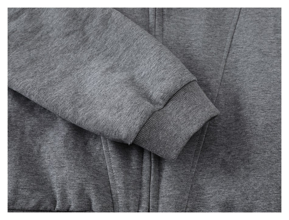 Close-up of a heather-gray jacket sleeve ending in a dark ribbed cuff.