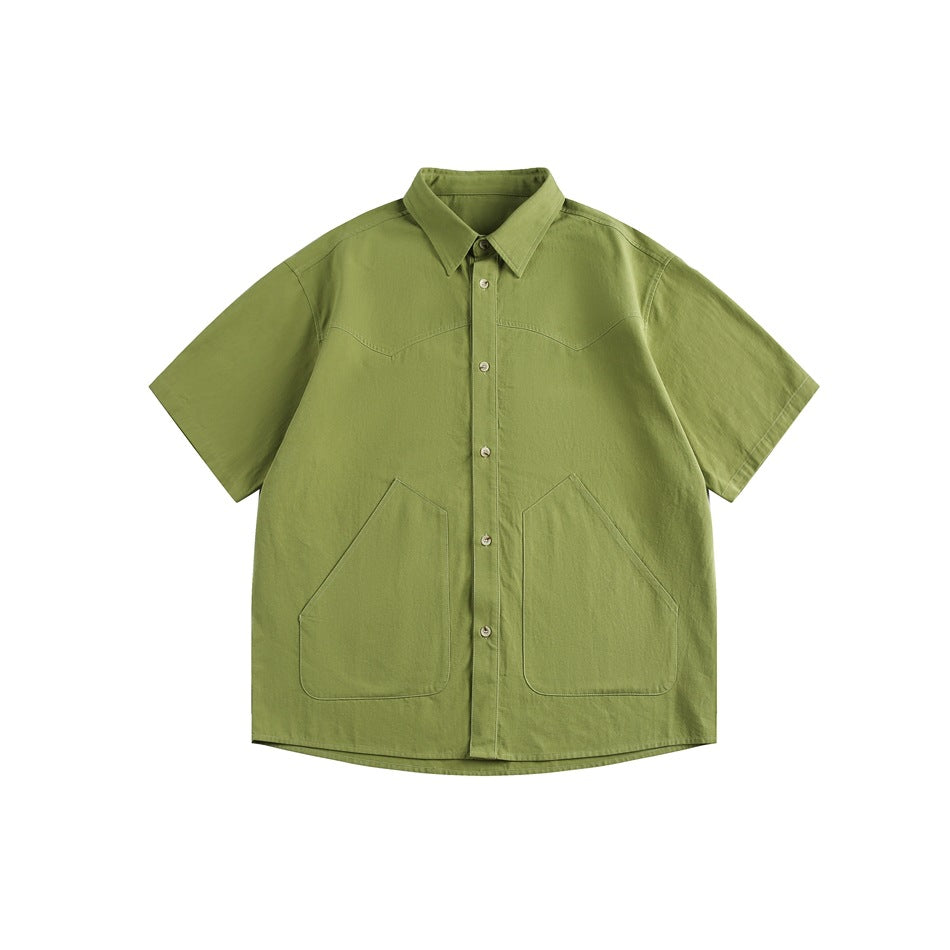 Green short-sleeve button-front shirt with pointed collar and two large angular front pockets, flat lay