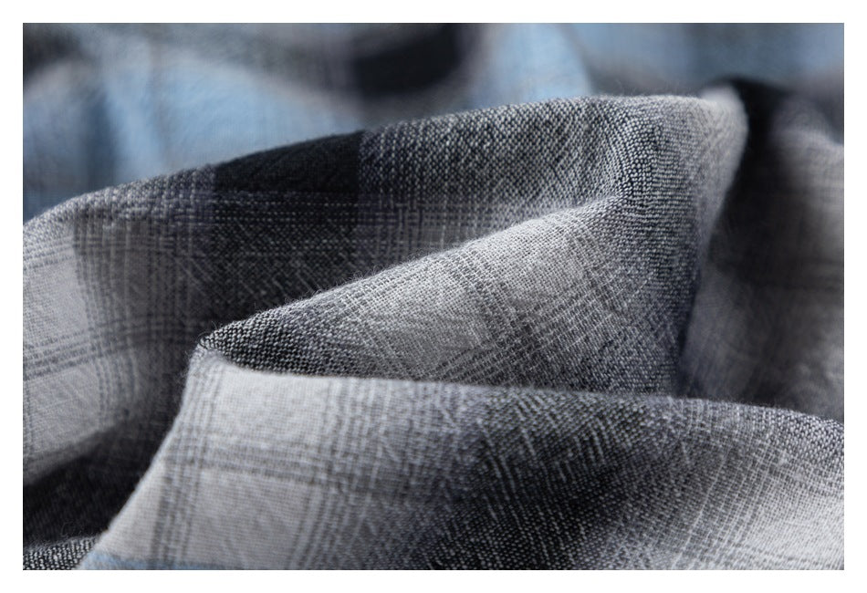 Macro view of the gray and black plaid fabric showing its woven texture.