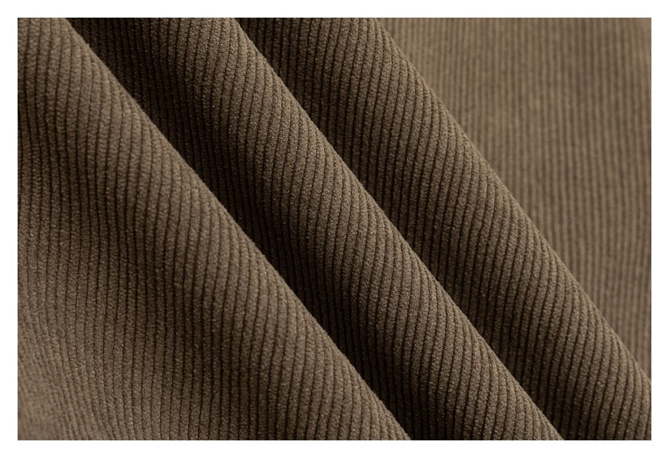 Macro view of taupe ribbed fabric folds showing its raised vertical texture.