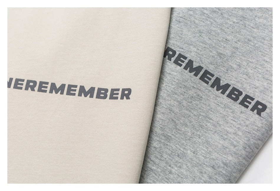 Close-up of cream and heather-gray fabric panels with dark printed lettering.
