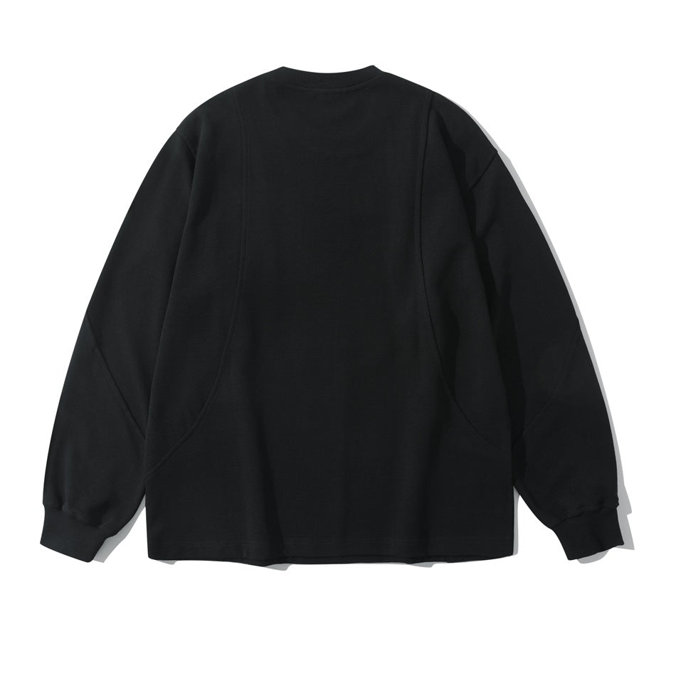 Back view of a black long-sleeve crew neck pullover with curved seam panels and ribbed cuffs, shown flat
