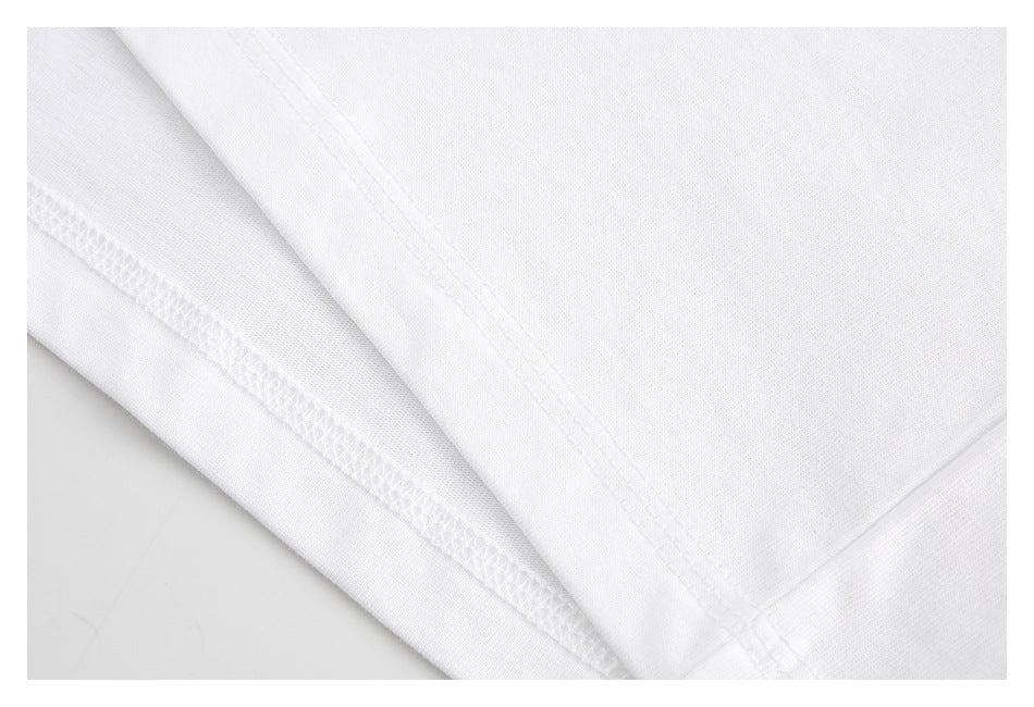 Close-up of white garment fabric with an overlocked seam and parallel stitching.
