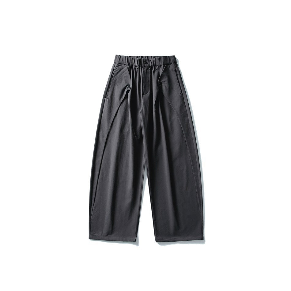 Dark gray wide-leg pants with elastic waistband, front button and curved seams, flat front view