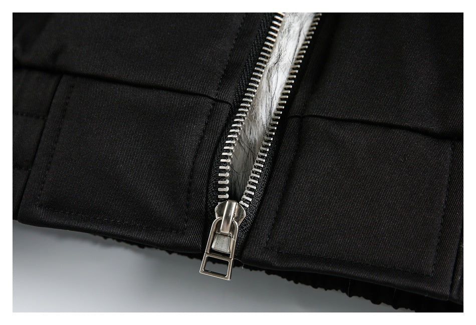 Close-up of a silver zipper between black jacket panels, with white fur visible beneath.