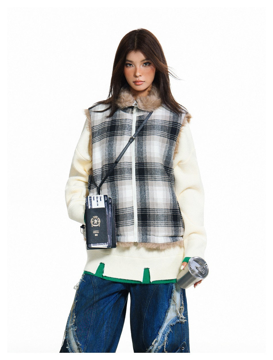 Model wearing a gray plaid zip vest with a fur collar over a cream sweater and distressed blue jeans.