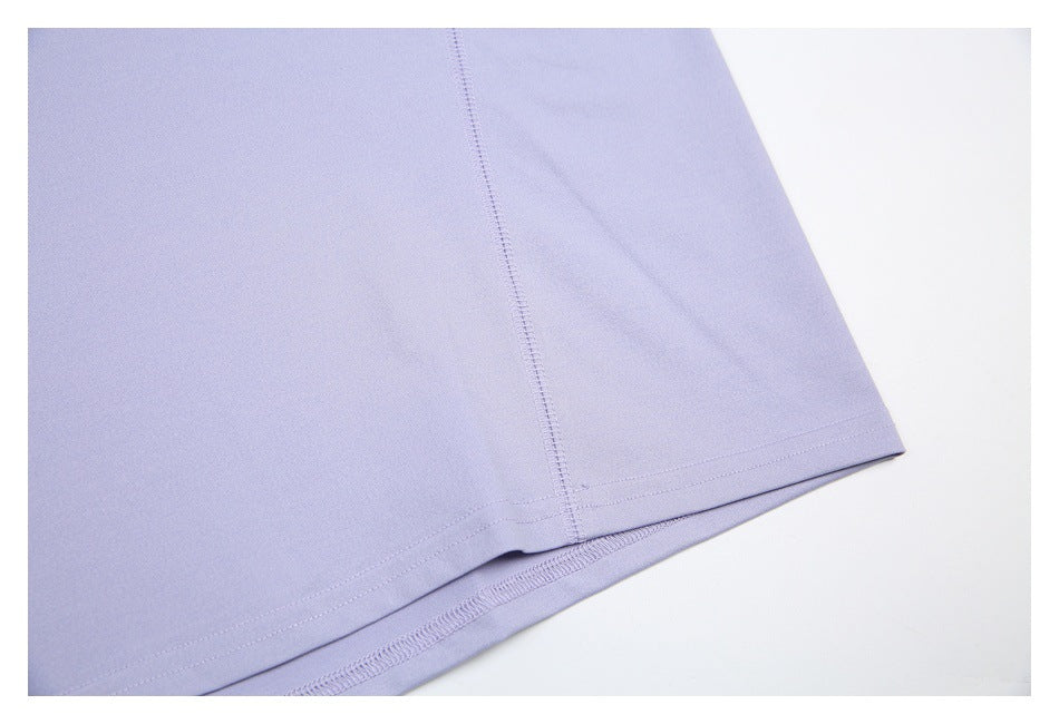 Close-up of a lavender garment hem and vertical seam stitching.
