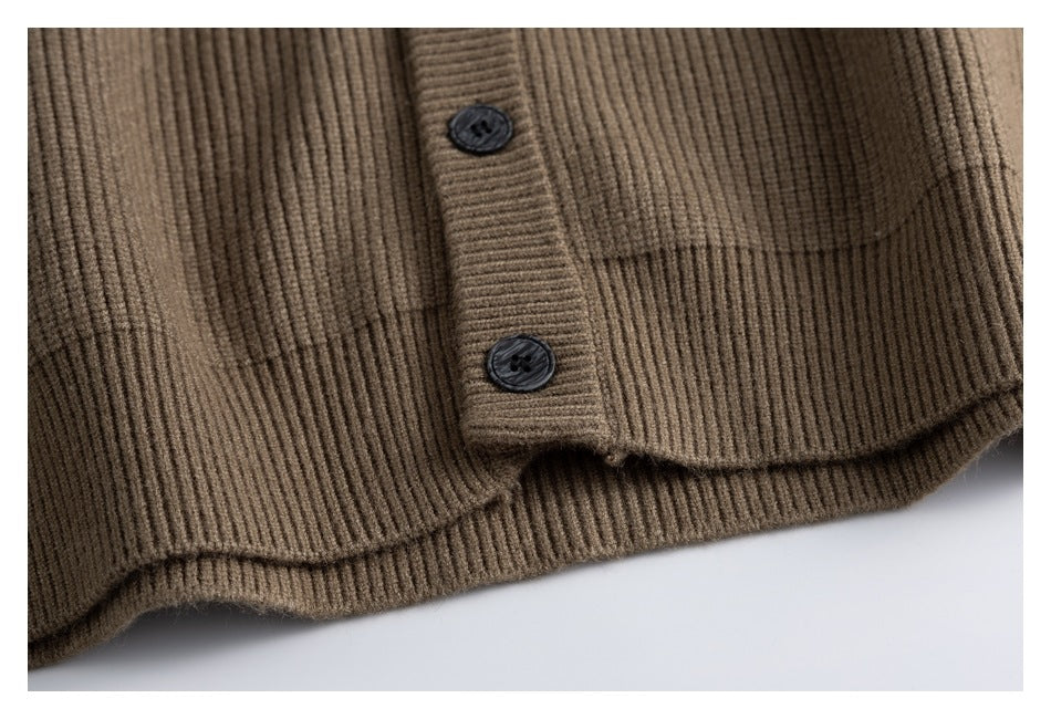 Close-up of the brown rib-knit cardigan hem and buttoned front placket.