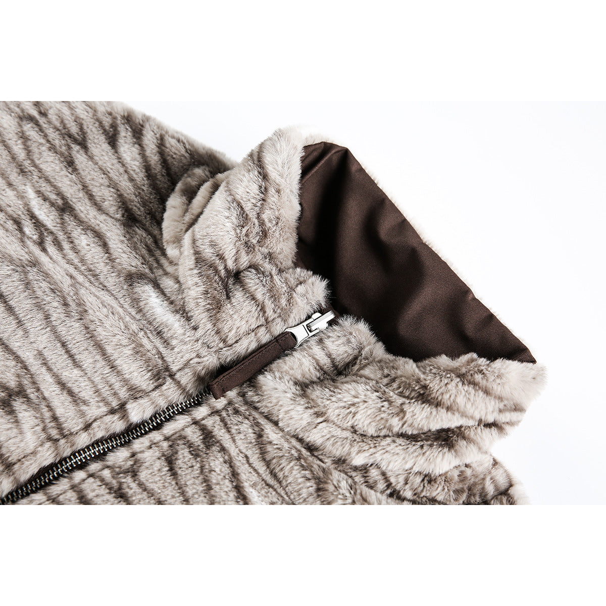 Close-up of a gray patterned plush jacket collar, brown lining, and front zipper.
