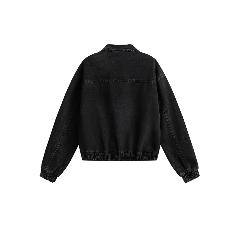Back view of a black denim jacket with a short stand collar, long sleeves, and gathered cuffs and hem.